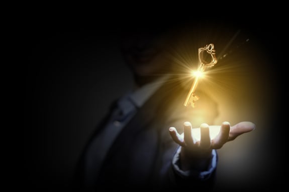 Close up image of business person holding shining key-1