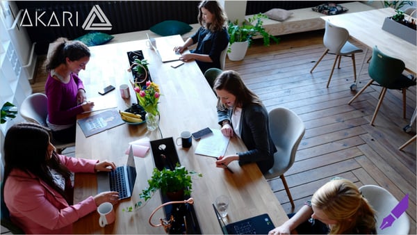 Women working at a long table together