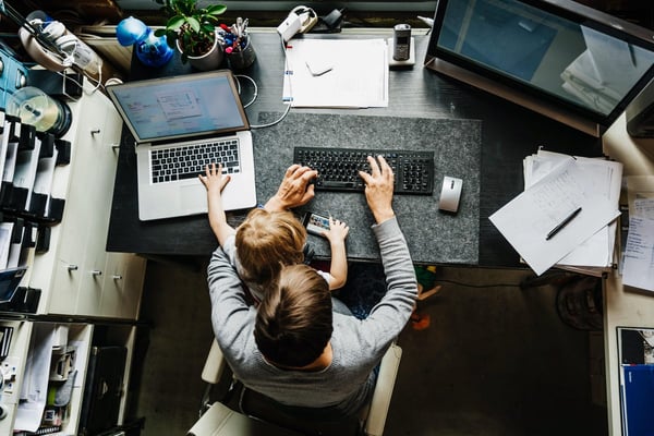 Bird's eye view of man and child working at desk
