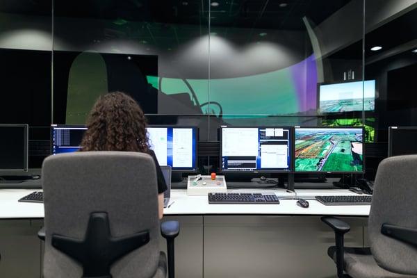 person sat at workstation (image for blog Beyond the Power BI dashboard: how to make better data-driven decisions)