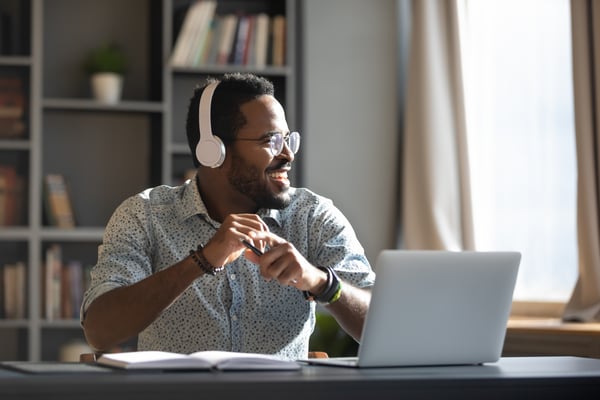 Man smiling while on a work call from home