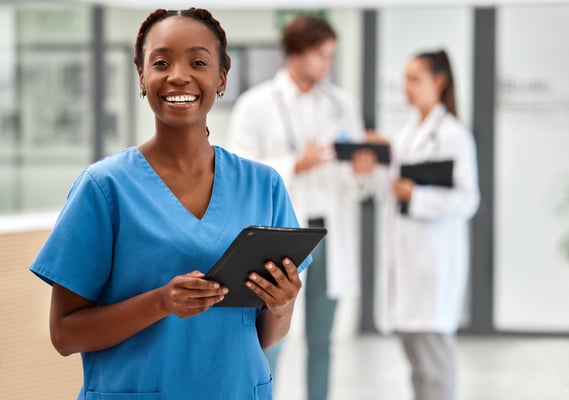 Smiling NHS worker on Ipad